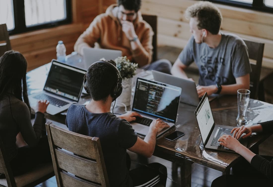 An agency team working together on laptops
