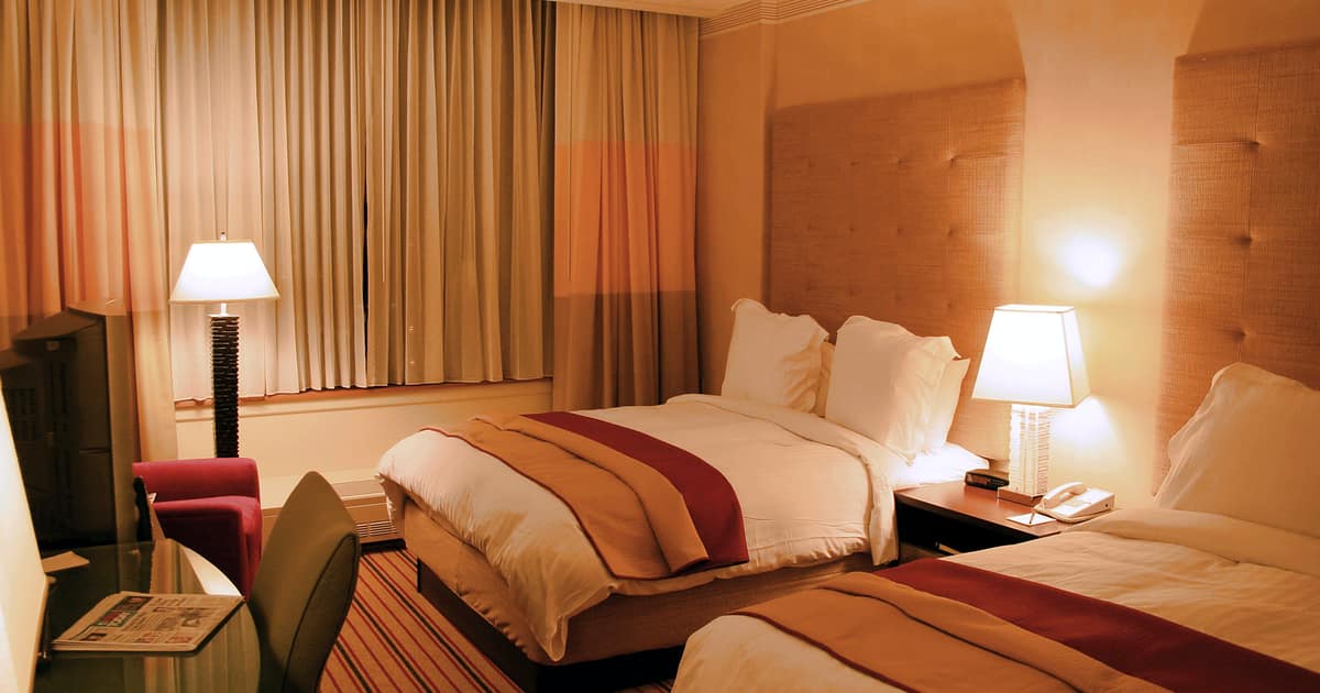 A warm hotel room with two beds and soft lighting, the stay local citations for hotels should point guests toward.