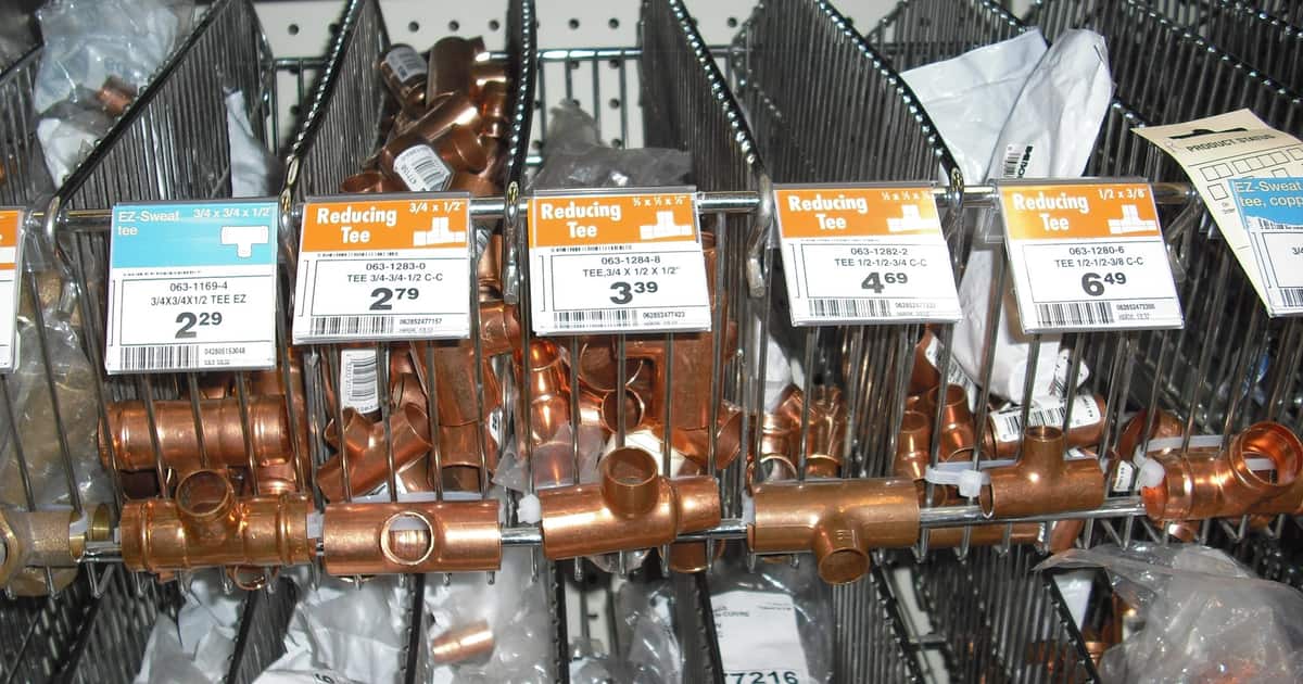 Copper pipe fittings on a hardware shelf, the parts behind the jobs citation building for plumbers helps win.