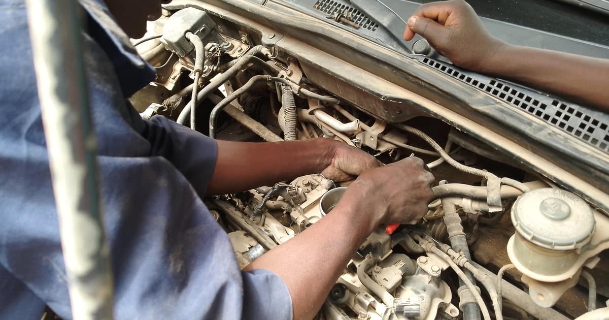 A mechanic's hands repairing a car engine, the trade local SEO for auto repair shops needs to rank for