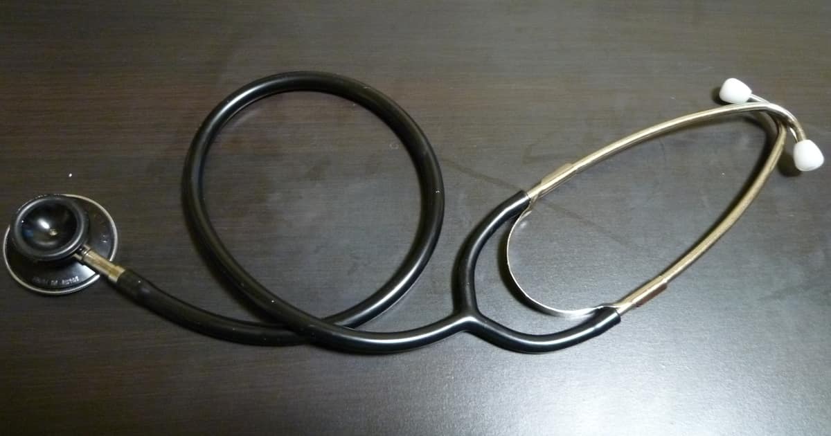A stethoscope resting on a dark desk, a simple symbol of the care local SEO for doctors helps patients find nearby.